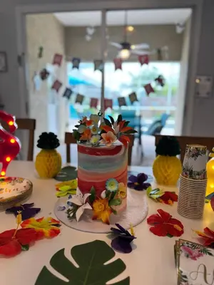 a birthday cake on a table with flowers on it at Chatham House in Kissimmee