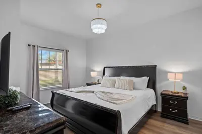 a bedroom with a large bed and a window at Modern 3 Bed Villa Newly Renovated Prime Location in Kissimmee