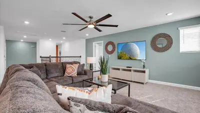 a living room with a couch and a ceiling fan at Sierra Sky in Kissimmee
