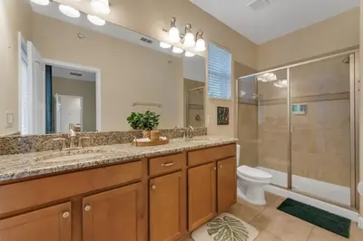 a bathroom with a sink and a shower and a toilet at 5BD - Movie Room, Pool, BBQ - Near Disney World in Kissimmee
