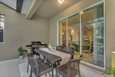 a dining room with a table and chairs at 5BD - Movie Room, Pool, BBQ - Near Disney World in Kissimmee