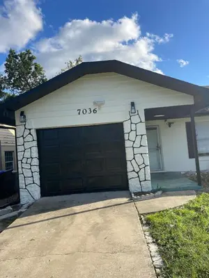 a house with a garage with at Cozy Haven with Premier Privacy 4 bedroom in Orlando