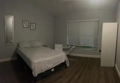 a bedroom with a bed and a window at Cozy Haven with Premier Privacy 4 bedroom in Orlando