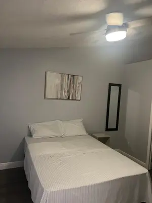 a bedroom with a bed and a ceiling fan at Cozy Haven with Premier Privacy 4 bedroom in Orlando