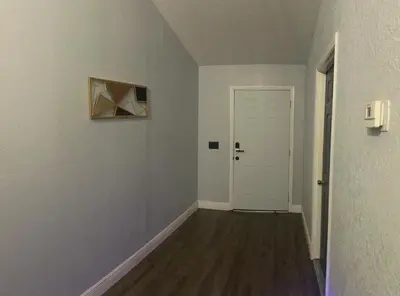 an empty room with a white door and a hallway at Cozy Haven with Premier Privacy 4 bedroom in Orlando
