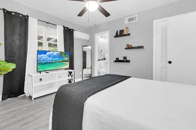 a bedroom with a bed and a flat screen tv at Modern Cuartito near Winter Park in Orlando