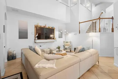 a living room with a large couch and a tv at Lux 6BrVilla -Pool&ResortAmenities -10mins to Parks in Kissimmee