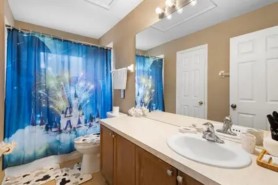 a bathroom with a sink and a toilet at Lux 6BrVilla -Pool&ResortAmenities -10mins to Parks in Kissimmee