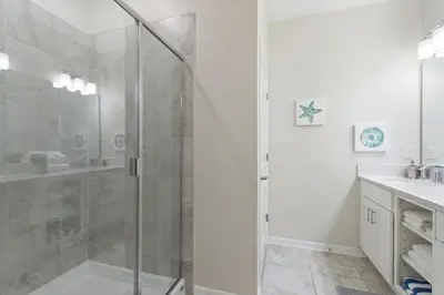 a bathroom with a shower with a glass door at Storey Lake Resort 2bd Condo Overlooking Water #840 condo in Kissimmee
