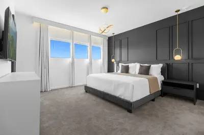 a bedroom with a large bed and a bathroom at Brand NEW 9Bedrooms9Bathrooms At Paradiso Grande in Orlando