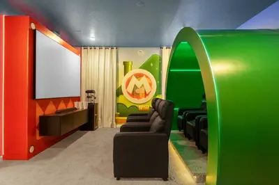 a living room with a couch and a green wall at Brand NEW 9Bedrooms9Bathrooms At Paradiso Grande in Orlando