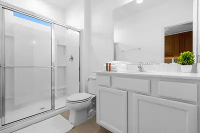 a white bathroom with a toilet and a shower at Brand NEW 9Bedrooms9Bathrooms At Paradiso Grande in Orlando