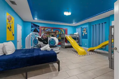 a bedroom with a bed and a slide at 9 min to Disney w Pool ARCADE FREE Waterpark Villa in Kissimmee