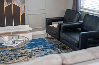 a living room with two chairs and a coffee table at 9 min to Disney w Pool ARCADE FREE Waterpark Villa in Kissimmee