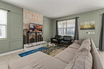 a living room with a couch and two chairs at 9 min to Disney w Pool ARCADE FREE Waterpark Villa in Kissimmee