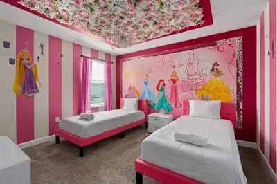 a bedroom with two beds and a princess mural at 9 min to Disney w Pool ARCADE FREE Waterpark Villa in Kissimmee