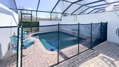 a swimming pool in a house with a glass enclosure at Tequilla Sunrise at Windsor Hills in Orlando
