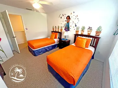 two beds in a room with orange sheets at Villas Standard Seven Dwrafs Resort - Close to Disney in Kissimmee
