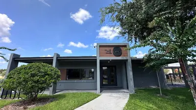 a building with a clock on the front of it at 3221 Brand New Family 3BD Townhouse near Disney in Kissimmee