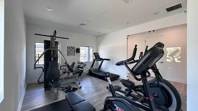 a gym with several exercise bikes in a room at 3221 Brand New Family 3BD Townhouse near Disney in Kissimmee