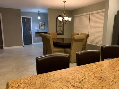a dining room and living room with a table and chairs at Lakefront Home Where You Can Retreat and Relax in Orlando