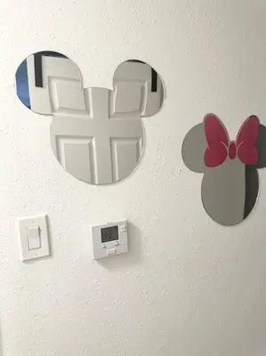 a apple sign on a wall with a clock at The Pink House of Celebration in Kissimmee