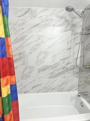 a bathroom with a shower curtain and a tub at The Pink House of Celebration in Kissimmee