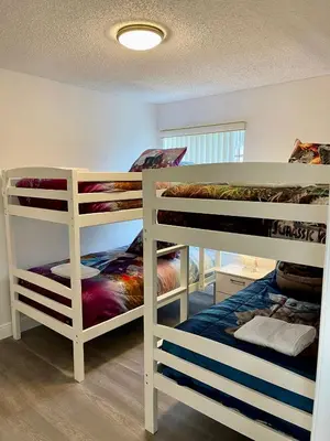 a room with three bunk beds in a room at Luxury Getaway 3BR Apartment near Disney Parks in Kissimmee
