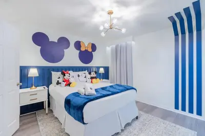 a blue and white bedroom with a bed with stuffed animals on it at Family 4br House w Pool near to Disney Much More in Kissimmee