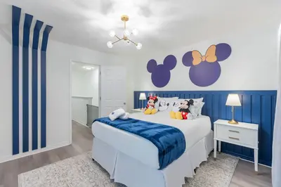 a blue and white bedroom with a white bed at Family 4br House w Pool near to Disney Much More in Kissimmee