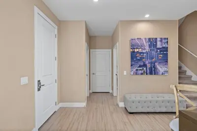 a hallway with a staircase and a painting on the wall at 3 Bedroom 4 Bathroom Magic Village 3099 in Orlando