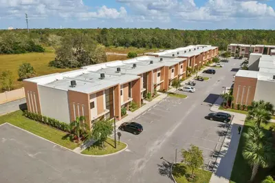 an aerial view of a parking lot with buildings at 3 Bedroom 4 Bathroom Magic Village 3099 in Orlando