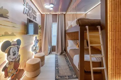 a bedroom with a bunk bed with a mickey mouse mural at 5 Bedroom 5 Bathroom Paradiso Grande 10352 in Orlando