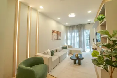 a living room with a white couch and a green chair at 5 Bedroom 5 Bathroom Paradiso Grande 10352 in Orlando