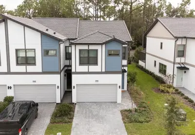 a house with a garage and a car at 5 Bedroom 5 Bathroom Paradiso Grande 10352 in Orlando