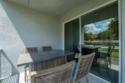 a patio with a table and chairs on a balcony at Themed 3-bed 2 bath condo at Storey Lake Resort in Kissimmee