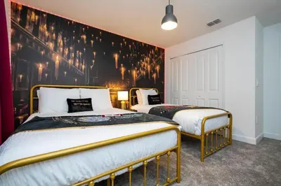 a bedroom with two beds and a black wall at 2557 Awesome Family 4BD Townhouse located at Storey Lake in Kissimmee