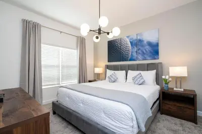 a bedroom with a large bed and a large window at 2557 Awesome Family 4BD Townhouse located at Storey Lake in Kissimmee