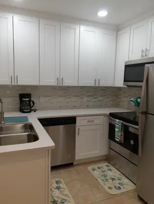 a kitchen with white cabinets and a sink at Venetian Bay Villages in Kissimmee