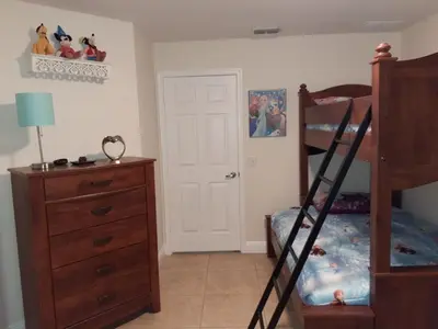 a bedroom with a bunk bed and a dresser at Venetian Bay Villages in Kissimmee