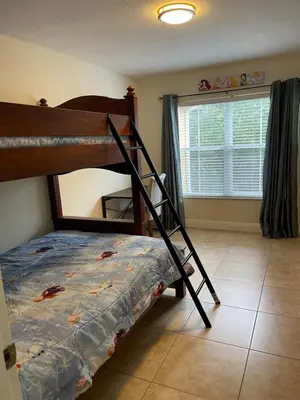 a bedroom with a bunk bed and a window at Venetian Bay Villages in Kissimmee