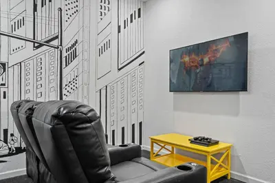 a black leather chair in a room with a table at Amazing House Amazing Amenities in Orlando