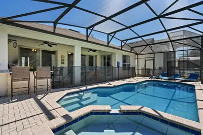a swimming pool with a glass roof on a house at Amazing House Amazing Amenities in Orlando