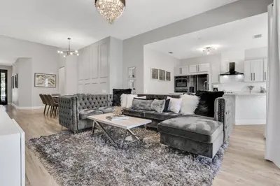 a living room with a couch and a table at Free Water Park Luxury Living in Orlando