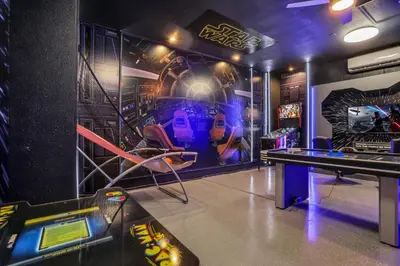 a gaming room with a table and a video game at Free Water Park Luxury Living in Orlando