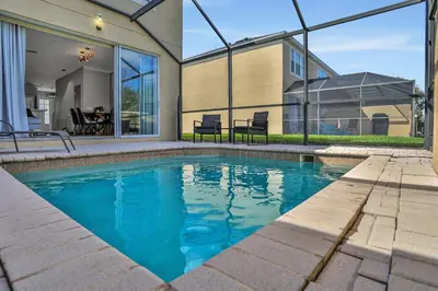 a swimming pool in front of a house at Windsor Hills Water Park Adventure Home in Orlando