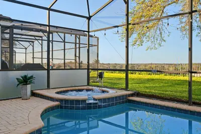 a hot tub in a building with a view of a field at 6BR Fun in the Sun with FREE water park in Orlando