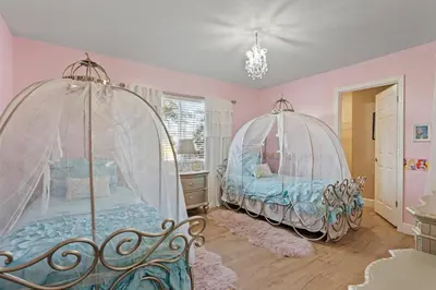 two beds in a room with pink walls at 6BR Fun in the Sun with FREE water park in Orlando