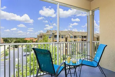 a balcony with a table and chairs on a balcony at Windsor Hills Condo: Water Park Included in Orlando