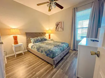 a bedroom with a bed and a ceiling fan at Family Fun 6BR Poolside w Water Park Game Room in Orlando